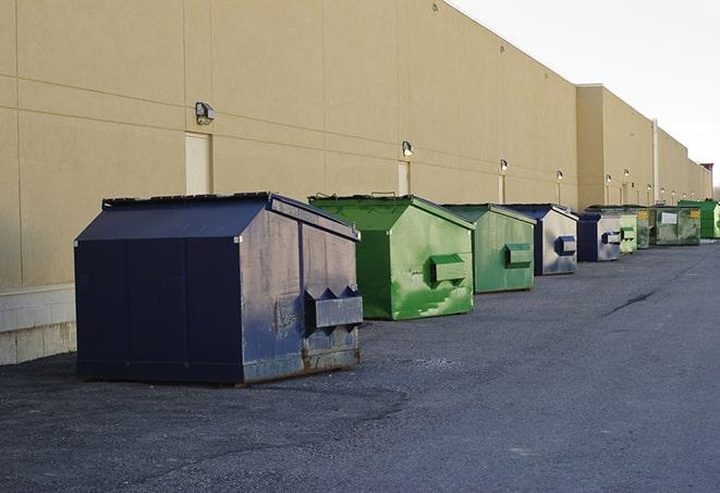 big yellow dumpsters on a construction lot in Cheektowaga NY